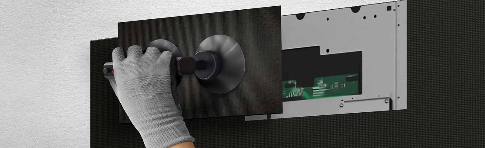 A person replaces one of the LED modules from the front using the provided suction cup tool.